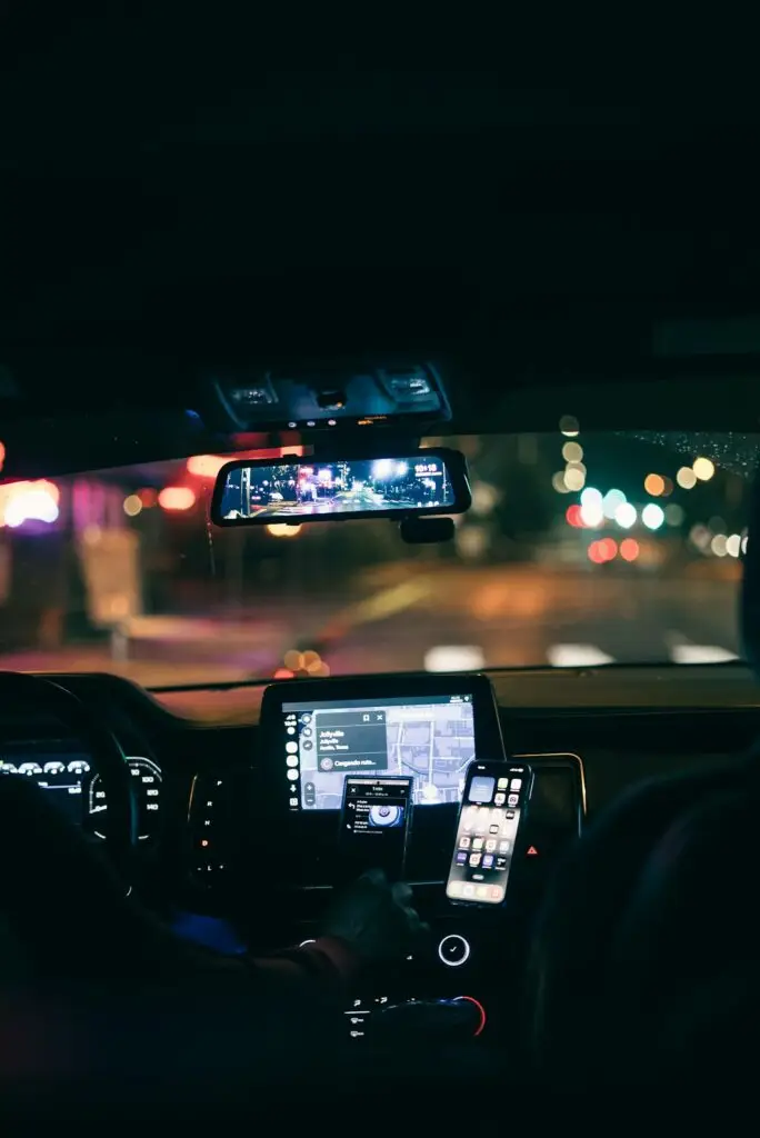 Rideshare driver at the wheel at night in the city, the setting for most Uber and Lyft accident insurance questions in California